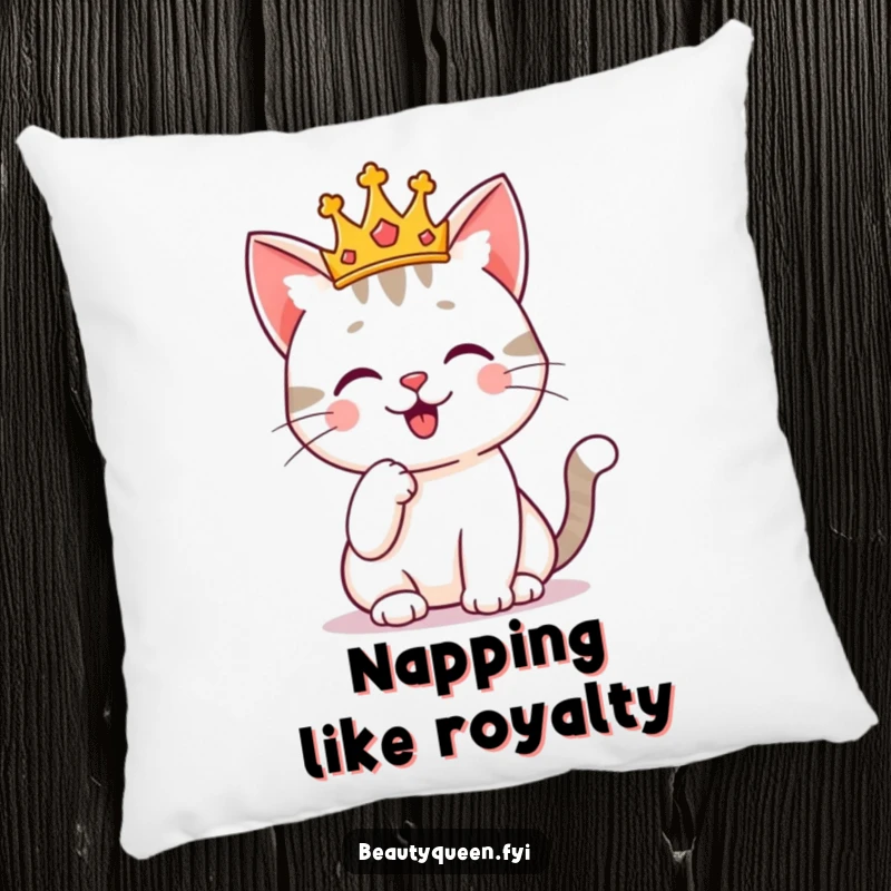 Funny cat with a tiny crown, posing regally with a paw on its chin, featured on a decorative pillow. Royal and cozy humor.