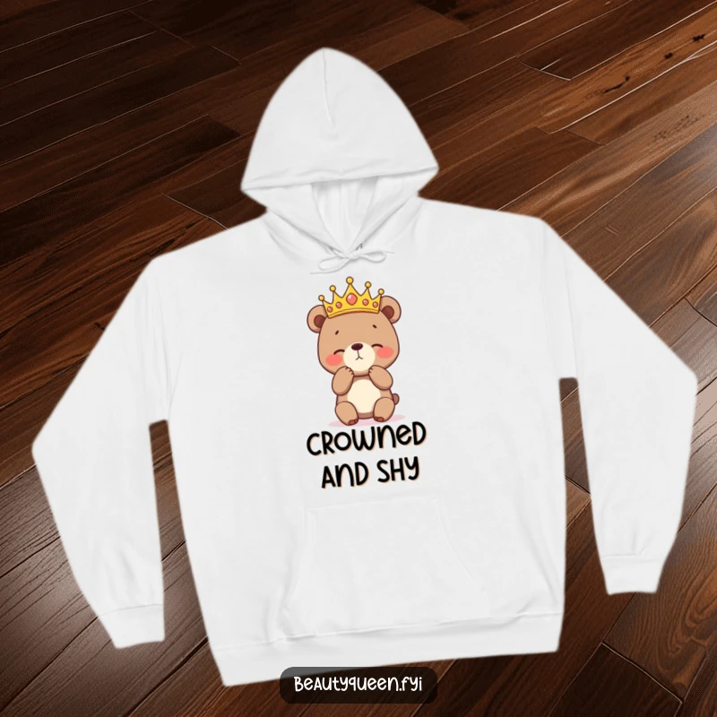 Funny hoodie depicting a bashful bear cub wearing a crown and practicing a curtsey, perfect for staying warm while exuding adorable, humorous charm.