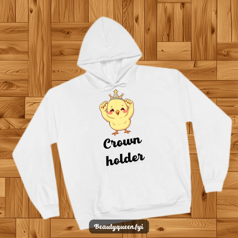 Funny hoodie design with a cheerful chick carefully adjusting a miniature tiara, radiating happiness and royalty.