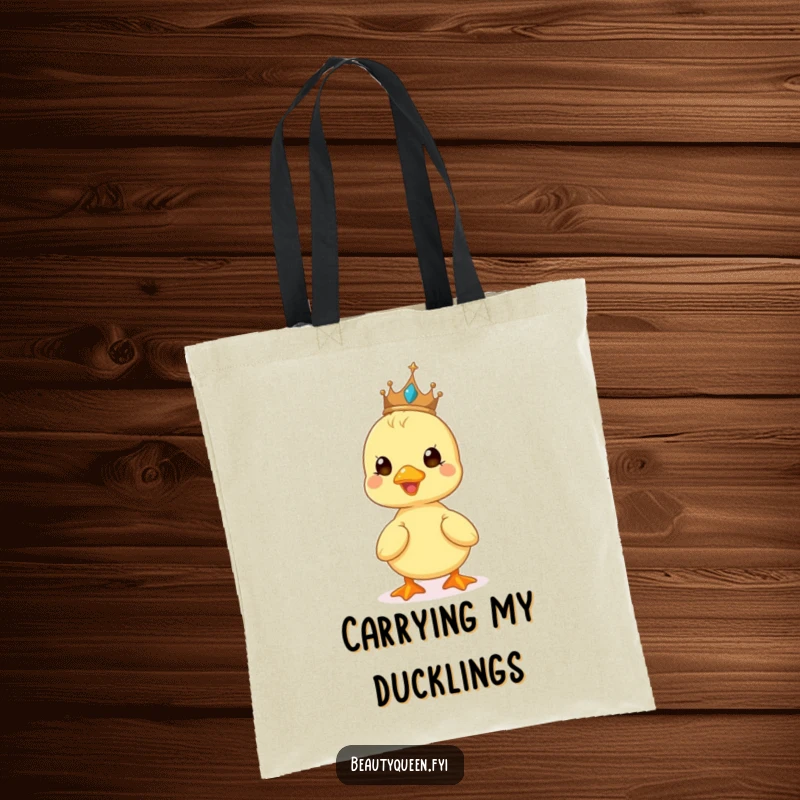 Funny tote bag showcasing a cute duckling beaming while wearing a tiny tiara, a delightful and humorous accessory.
